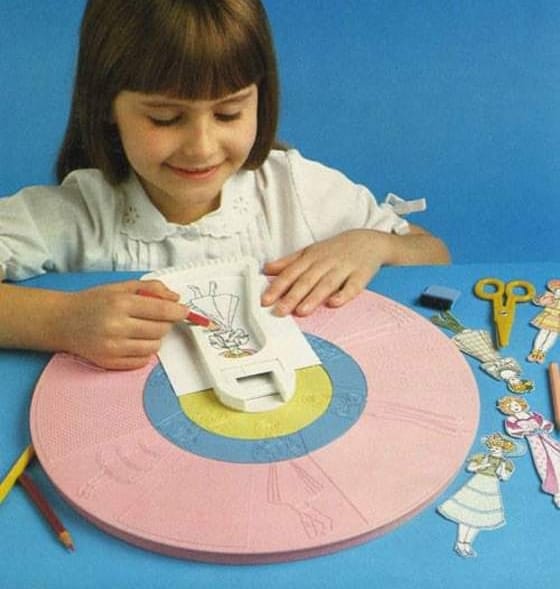 Niña dibujando con un juego de plantillas de moda.
