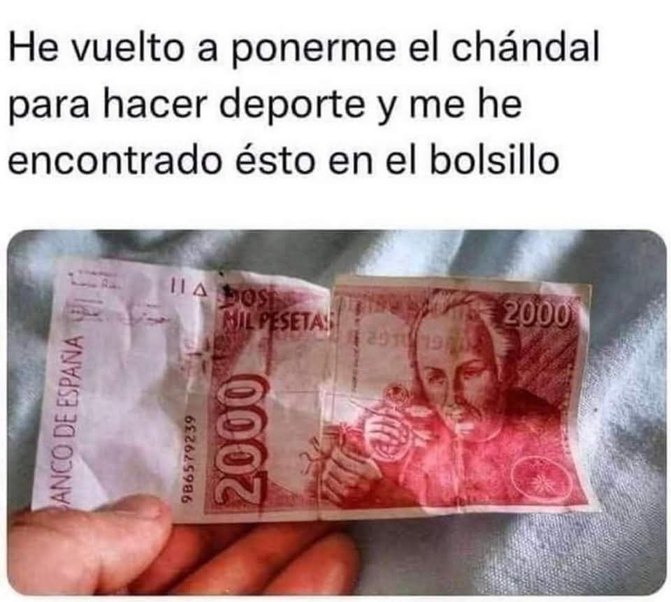 Mano sujetando un billete rojo de 2.000 pesetas arrugado.
