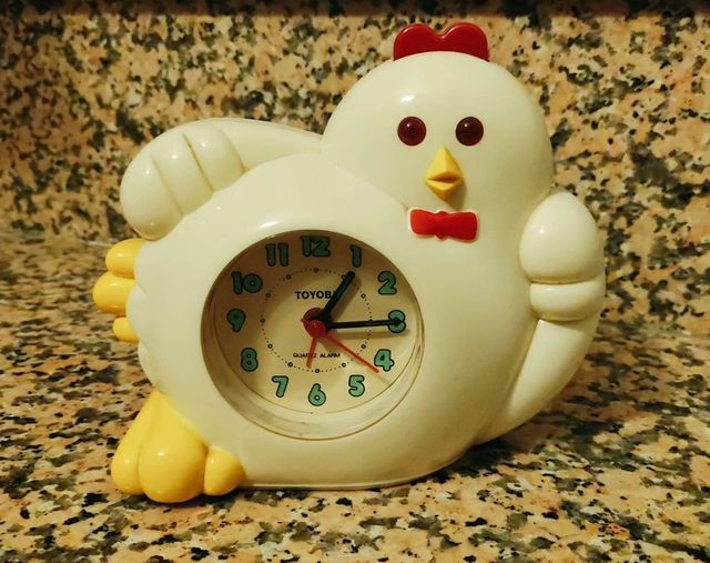 Despertador blanco con forma de gallina.