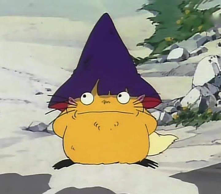 Personaje de dibujos con forma de sapo amarillo y sombrero morado