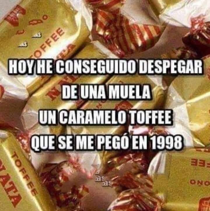 Montón de caramelos toffee de nata envueltos en papel dorado con rayas rojas.
