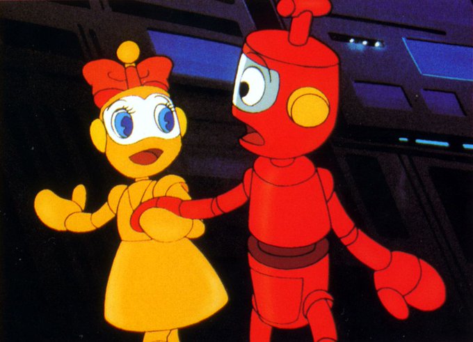 El robot Nono junto a una robot amarilla con lazo